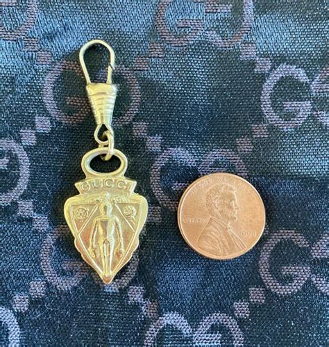 gucci gold tone metal tag and dangler knight crest purse|Gucci tags and tags.